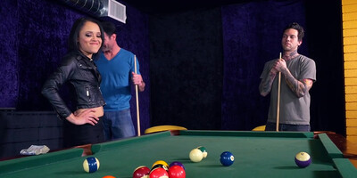 Dudes play pool when brunette in black leather joins them