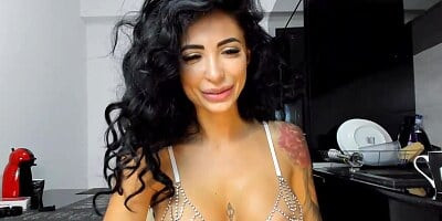 Gorgeous Latin brunette with big, firm tits is posing and teasing in front of the camera