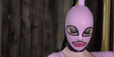 High heeled solo milf in latex dress and boots poses wearing a mask