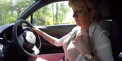 Mature blonde Lady Sonia plays with her tits while driving