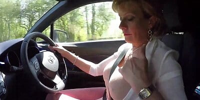 Mature blonde Lady Sonia plays with her tits while driving