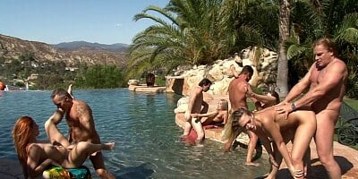Several women are getting fucked in a hot orgy by the pool