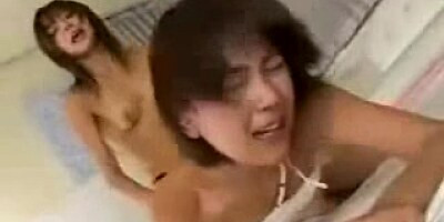 Two Japanese lesbian babes and a big strapon dick