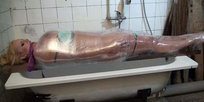 Vicky wrapped in plastic and gagged